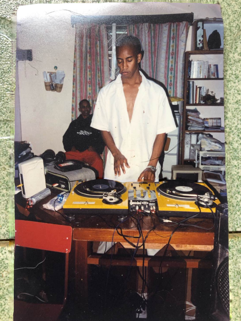 BerTz on turntables with mentor DJ Kingdom in the background — early years